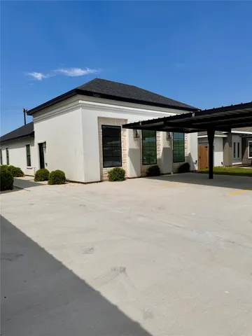 a view of a white house with a outdoor space