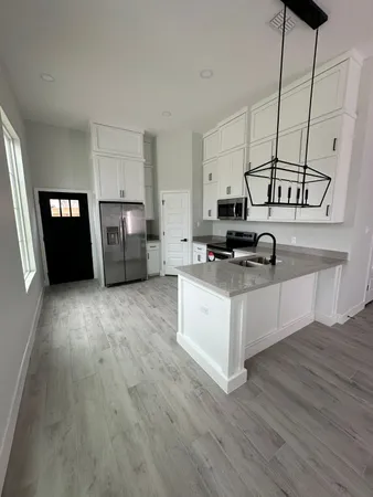 a kitchen with stainless steel appliances a stove top oven and a refrigerator
