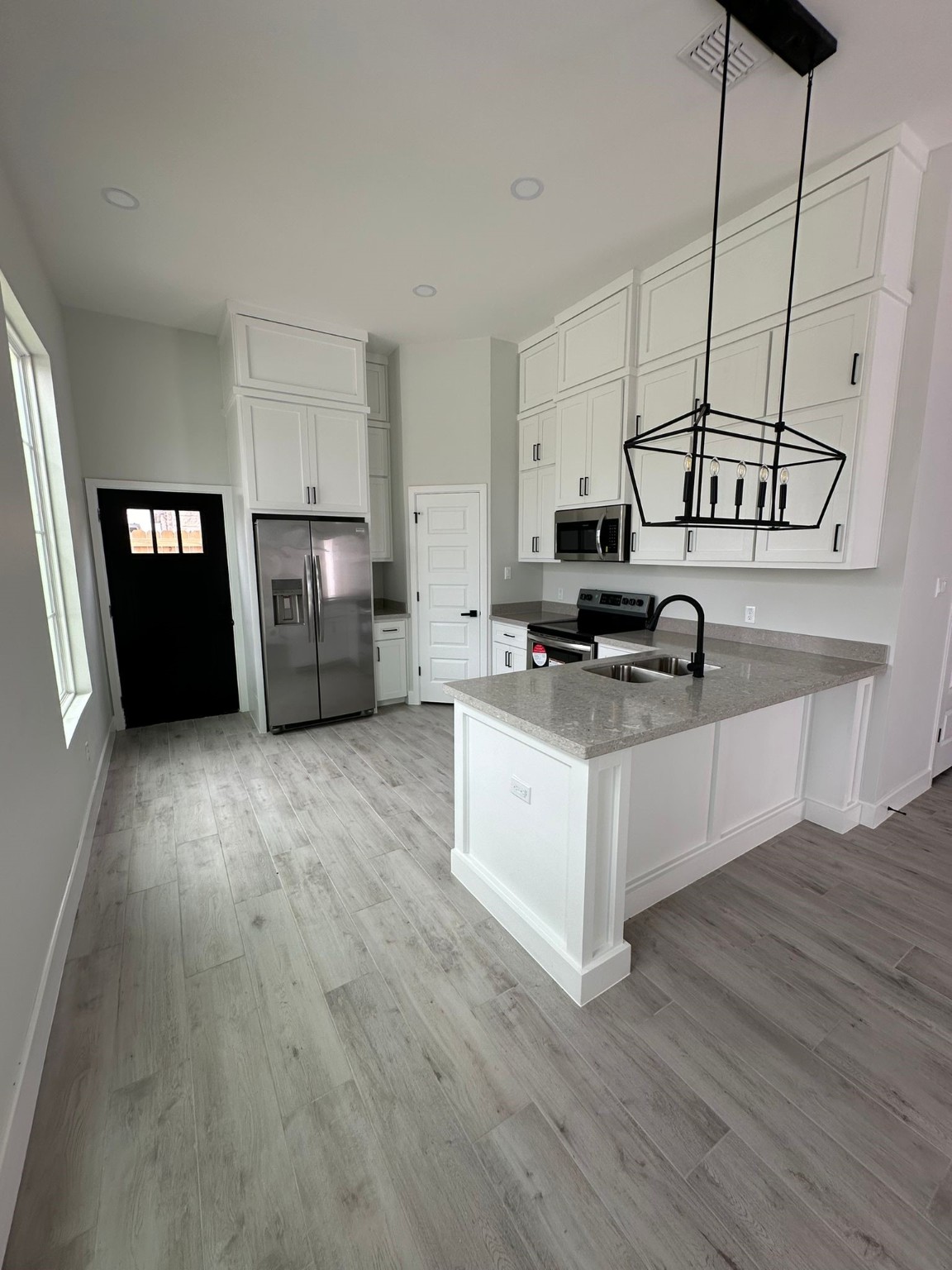 1409 South Xanthia Street Alton, TX 78573 - Photo 3 of 14 a kitchen with stainless steel appliances a stove top oven and a refrigerator