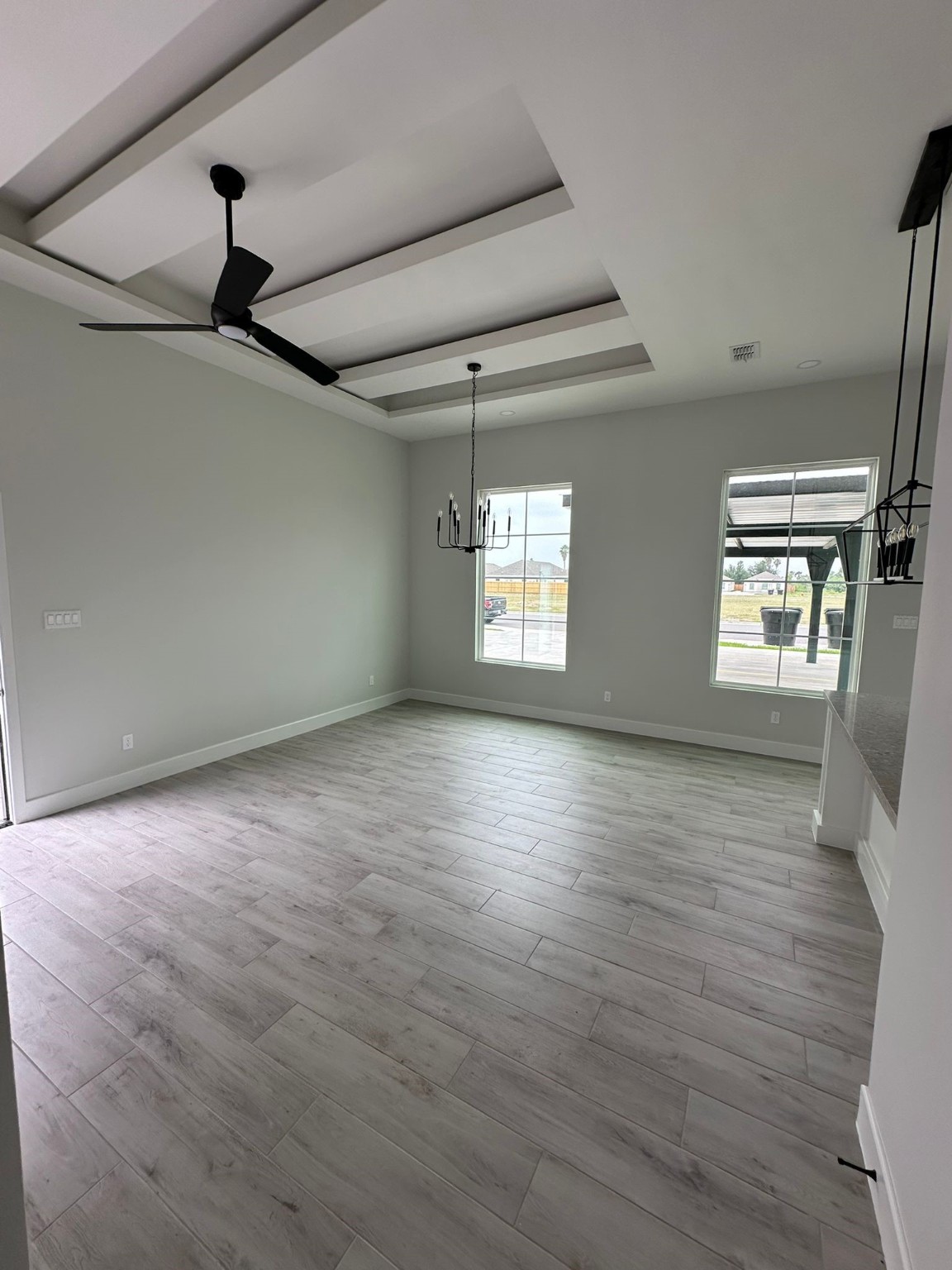 1409 South Xanthia Street Alton, TX 78573 - Photo 5 of 14 a view of an empty room with a window and wooden floor