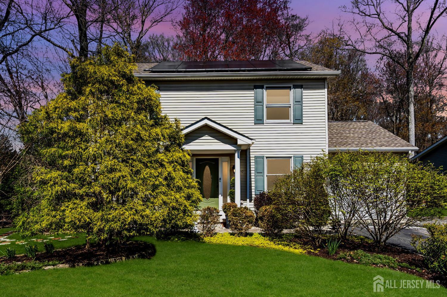 a front view of a house with a garden