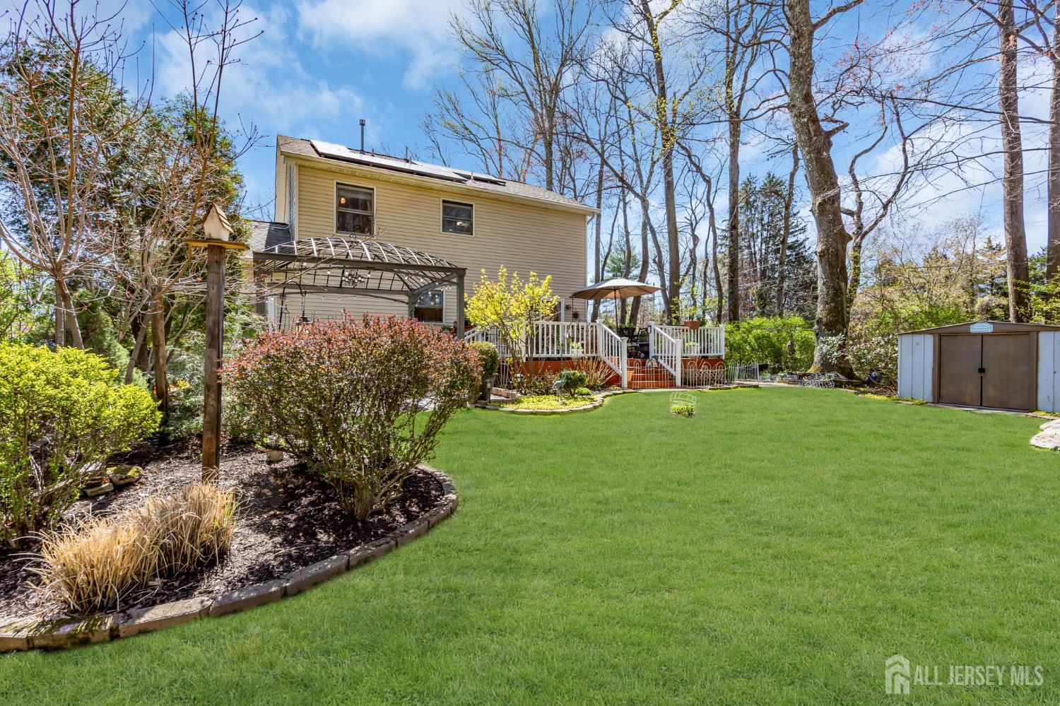 90 Bear Brook Road Princeton, NJ 08540 - Photo 49 of 60 a view of a backyard with plants and a patio
