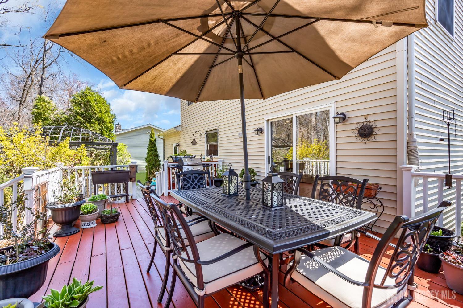 90 Bear Brook Road Princeton, NJ 08540 - Photo 59 of 60 a view of a patio with a table and chairs under an umbrella