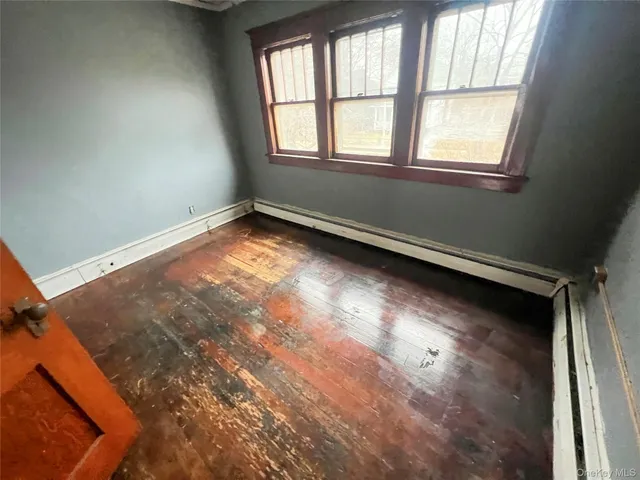 a view of a porch with wooden floor and furniture