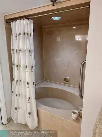 a bathroom with a shower and a tub