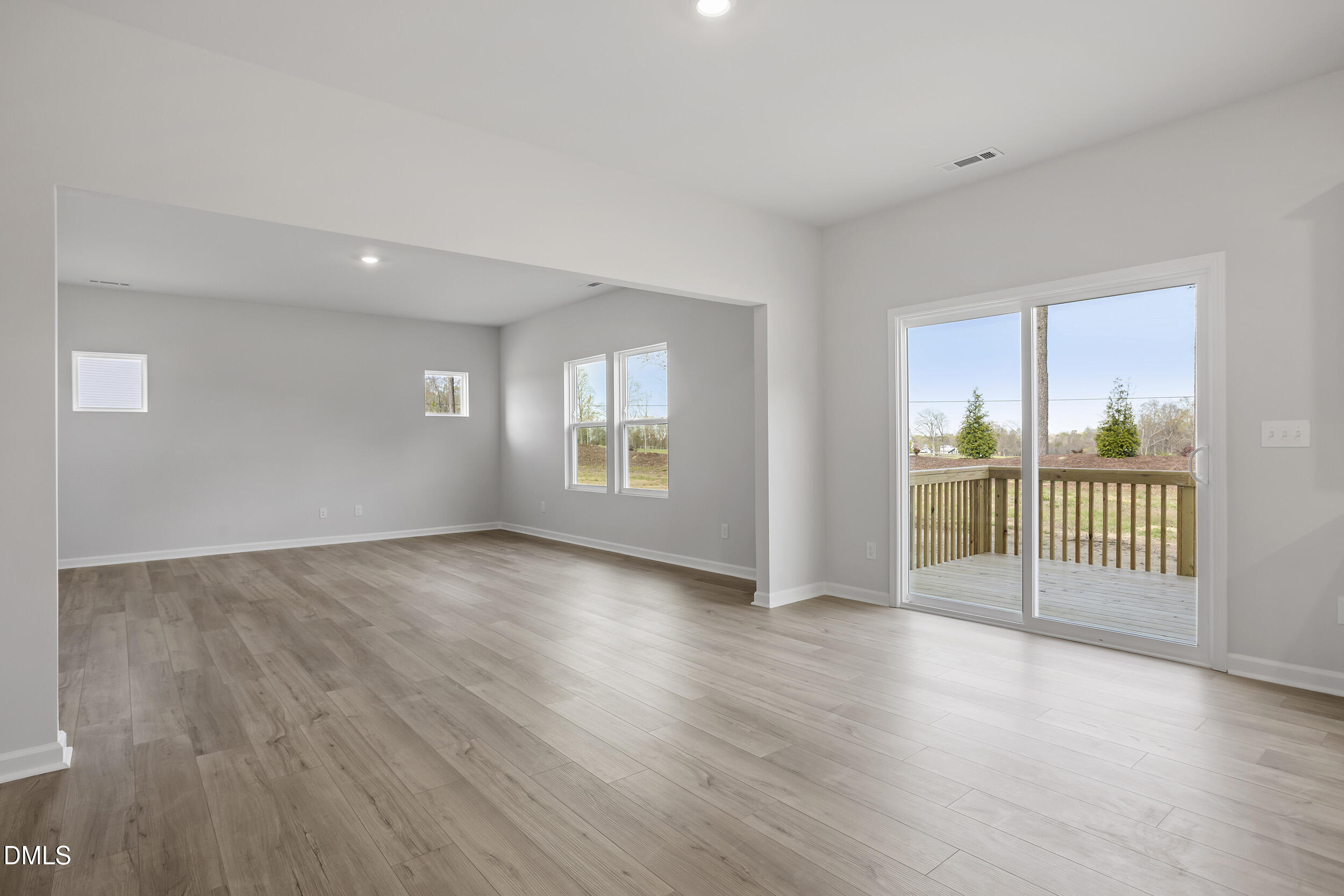67 Bainbridge Angier, NC 27501 - Photo 13 of 31 an empty room with wooden floor and windows