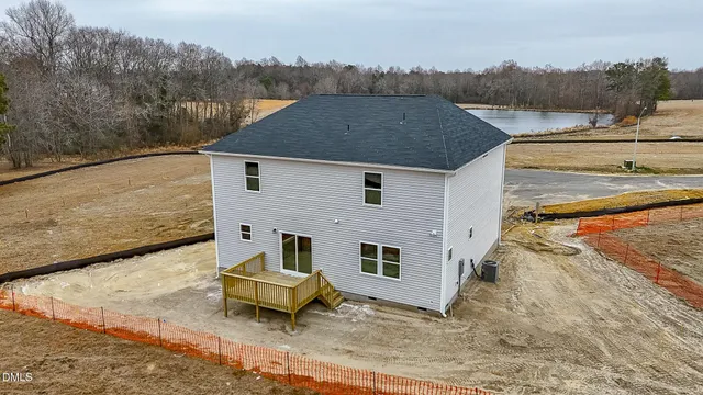 an aerial view of a house with a yard and lake view