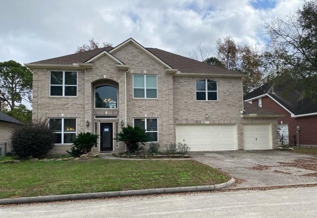 18810 Rusty Anchor Court Humble, TX 77346 - Photo 1 of 26 a front view of a house with a yard and garage