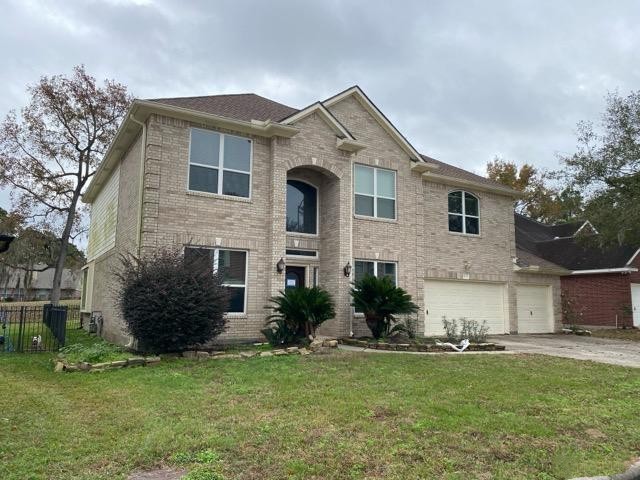 18810 Rusty Anchor Court Humble, TX 77346 - Photo 2 of 26 a front view of a house with a garden and plants