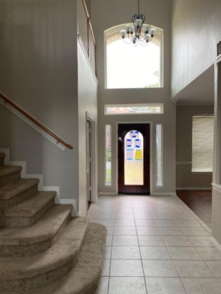 18810 Rusty Anchor Court Humble, TX 77346 - Photo 23 of 26 a view of a hallway with a window and a chandelier