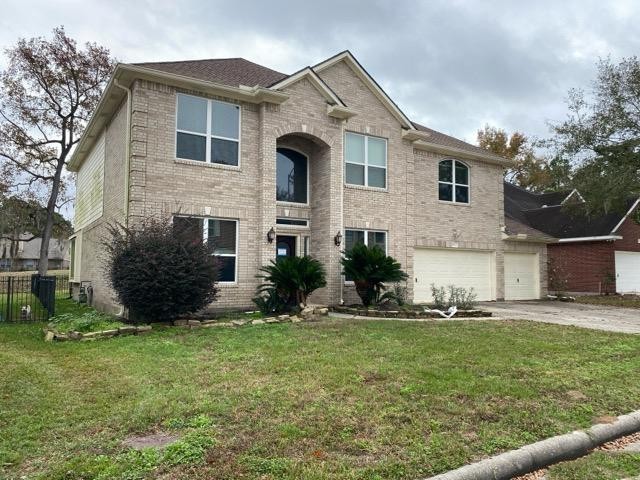 18810 Rusty Anchor Court Humble, TX 77346 - Photo 4 of 26 a front view of a house with a yard and outdoor seating