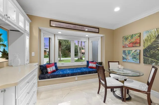 a living room with furniture and large windows