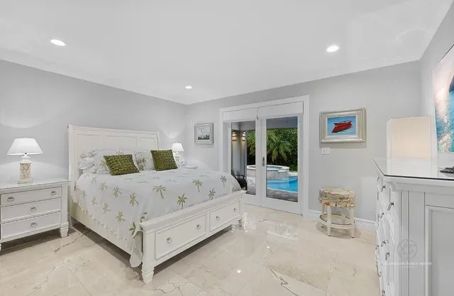 a bedroom with a bed and a large window