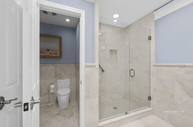 a bathroom with a shower a toilet and sink