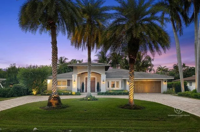 a front view of a house with a garden and a yard