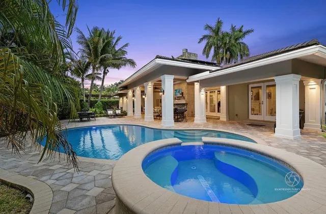 a view of a house with pool and sitting area