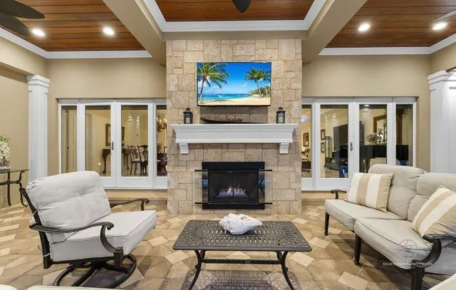 a living room with furniture a fireplace and a flat screen tv