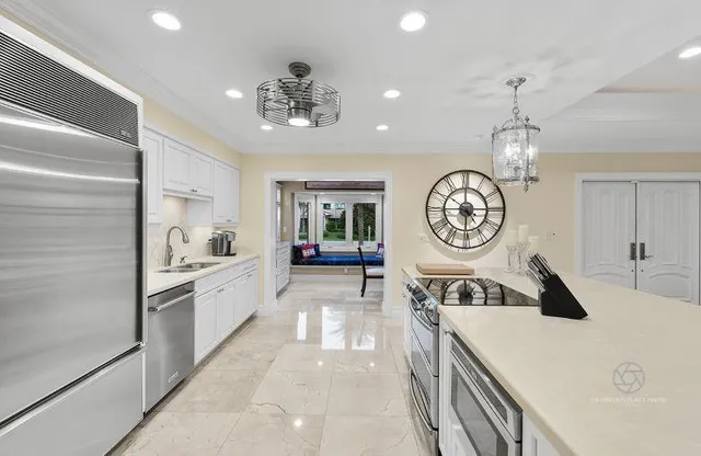 a very nice looking room with a large window table and kitchen view