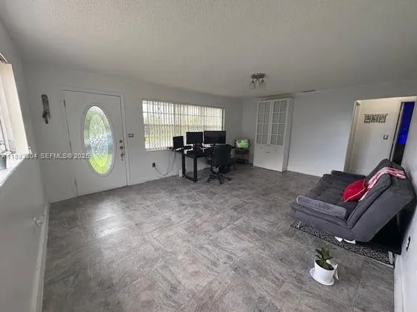 a living room with furniture and a window