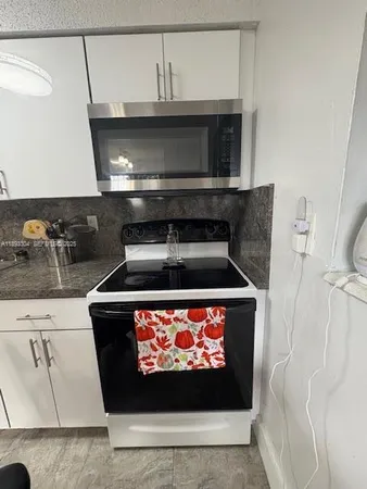a stove top oven sitting inside of a kitchen