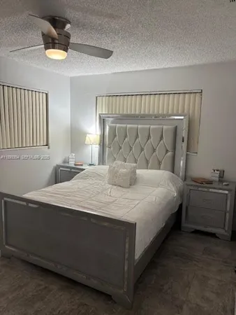 a spacious bedroom with a bed and window