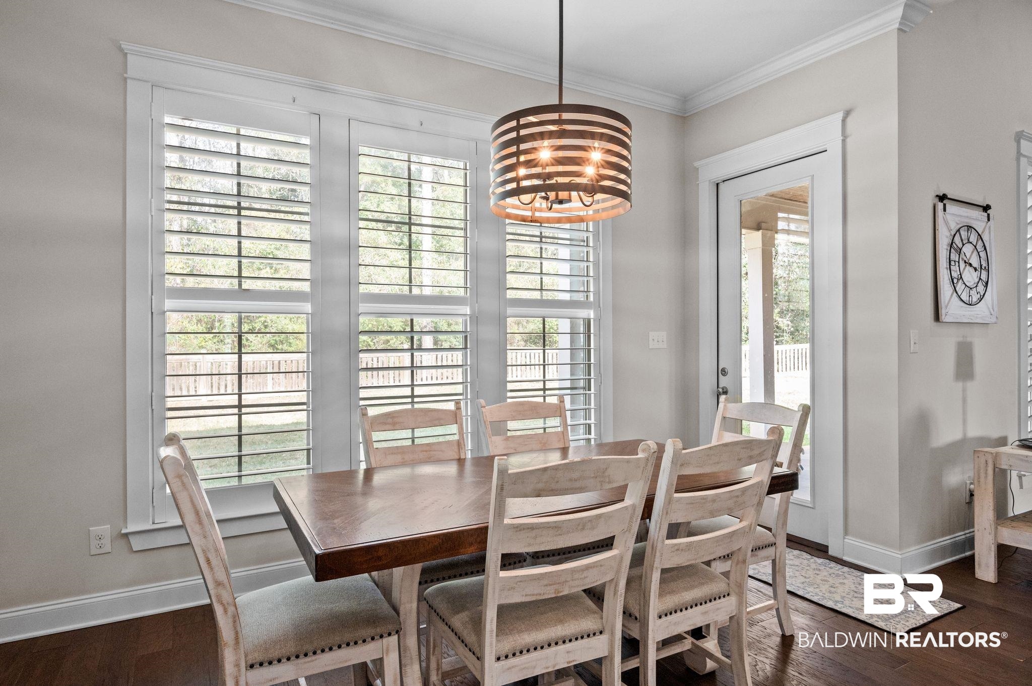 32194 Badger Court Daphne, AL 36527 - Photo 14 of 49 Dining room with crown molding and dark wood finished floors