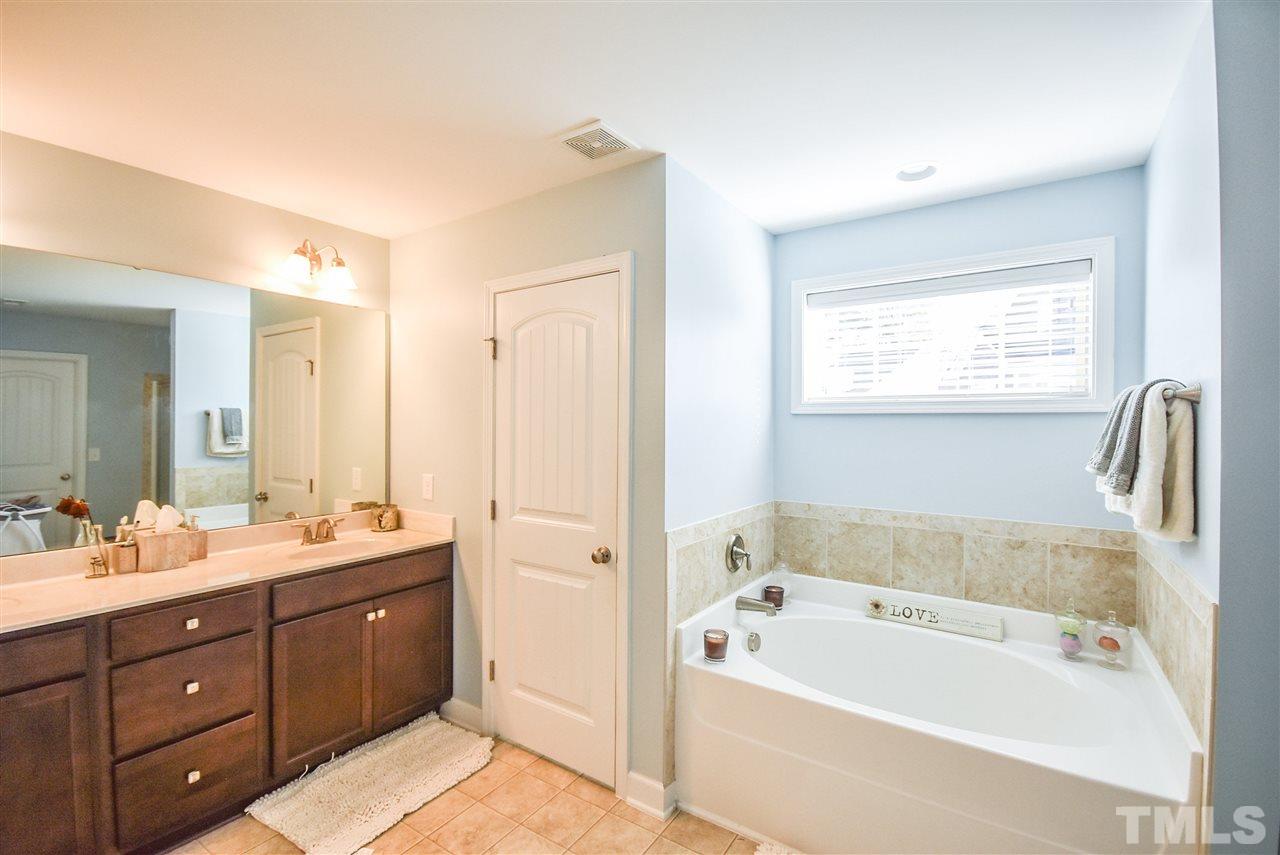 146 Shellbark Drive Spring Lake, NC 28390 - Photo 11 of 25 a bathroom with a tub sink and mirror