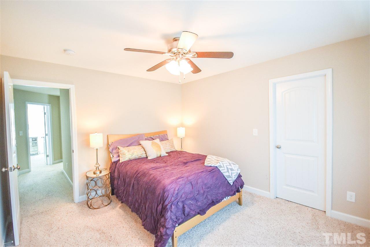 146 Shellbark Drive Spring Lake, NC 28390 - Photo 15 of 25 a bedroom with a bed and a chandelier