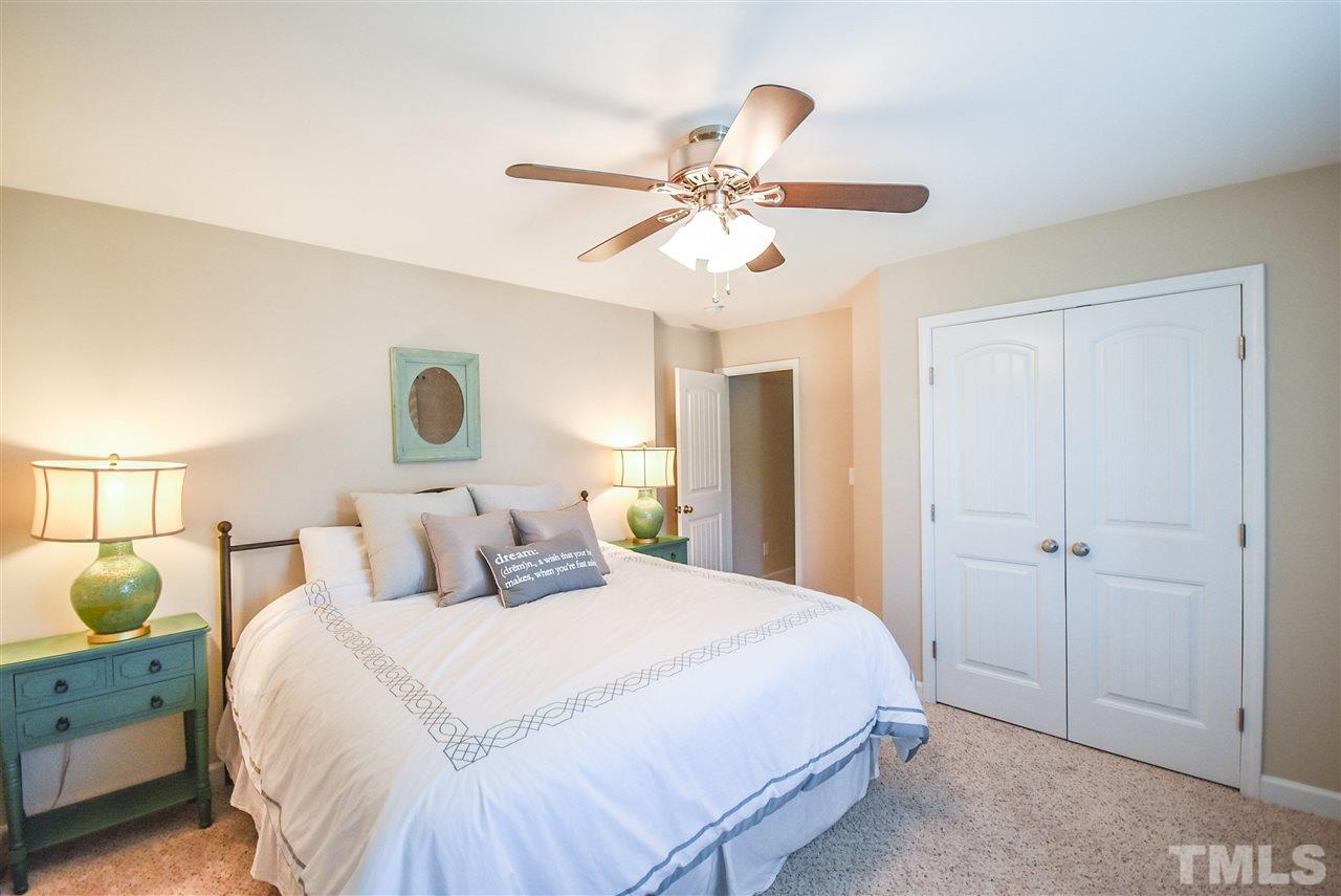 146 Shellbark Drive Spring Lake, NC 28390 - Photo 16 of 25 a bedroom with a bed and a chandelier