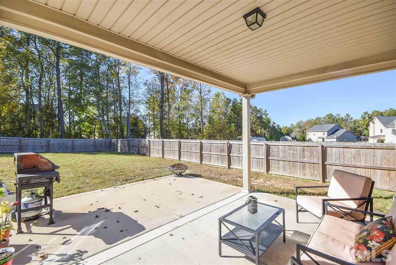 146 Shellbark Drive Spring Lake, NC 28390 - Photo 21 of 25 a view of a patio with a table chairs and wooden floor