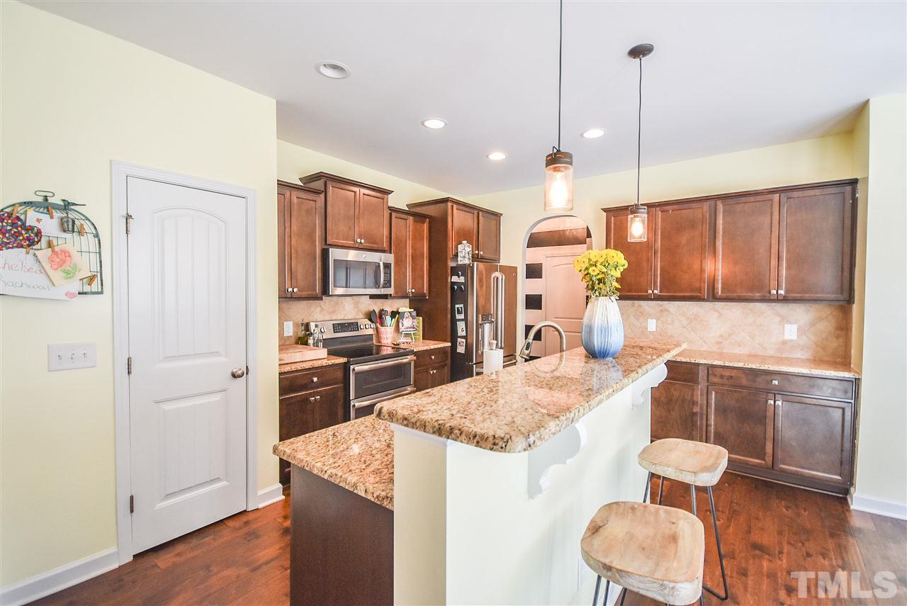 146 Shellbark Drive Spring Lake, NC 28390 - Photo 6 of 25 a kitchen with a refrigerator a stove top oven a sink and dishwasher