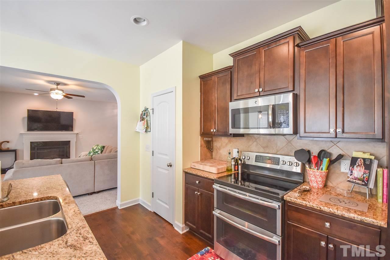 146 Shellbark Drive Spring Lake, NC 28390 - Photo 7 of 25 a kitchen with stainless steel appliances granite countertop a refrigerator and a stove top oven