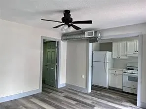 a kitchen view with stainless steel appliances a refrigerator and cabinets