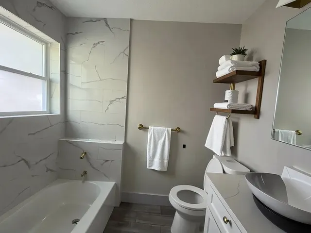 a bathroom with a sink toilet and bathtub
