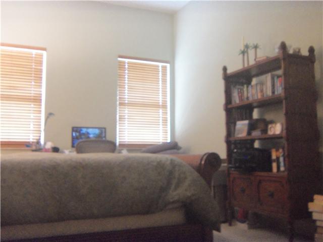 99 Southeast Mizner Boulevard, Unit 533 Boca Raton, FL 33432 - Photo 11 of 14 a bed sitting in a bedroom next to a window