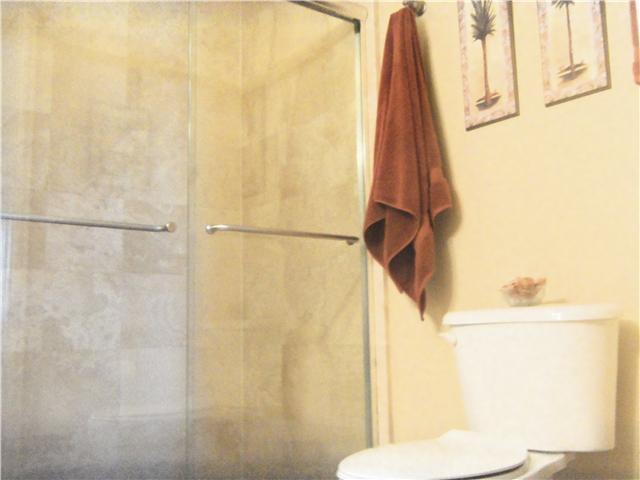 99 Southeast Mizner Boulevard, Unit 533 Boca Raton, FL 33432 - Photo 13 of 14 a bathroom with a toilet and a shower curtain