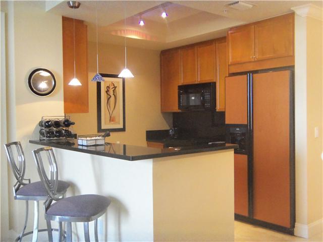 99 Southeast Mizner Boulevard, Unit 533 Boca Raton, FL 33432 - Photo 6 of 14 a view of a kitchen with a table and a chair