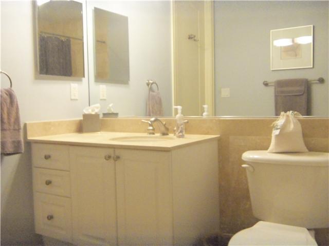99 Southeast Mizner Boulevard, Unit 533 Boca Raton, FL 33432 - Photo 8 of 14 a bathroom with a sink toilet and mirror