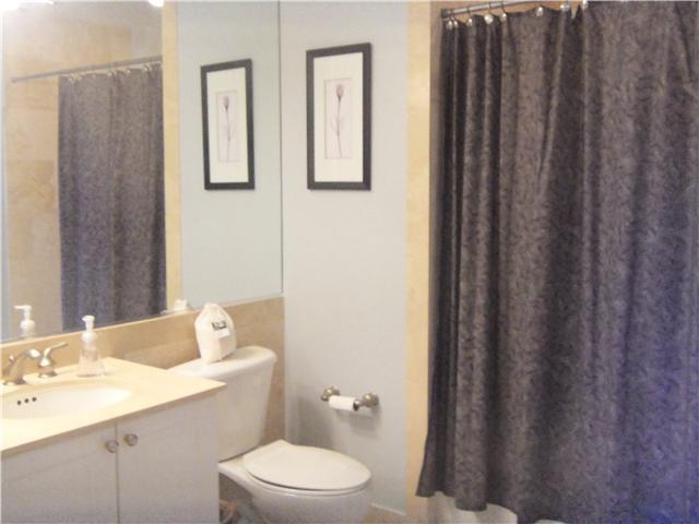 99 Southeast Mizner Boulevard, Unit 533 Boca Raton, FL 33432 - Photo 9 of 14 a bathroom with a sink a toilet and shower curtain
