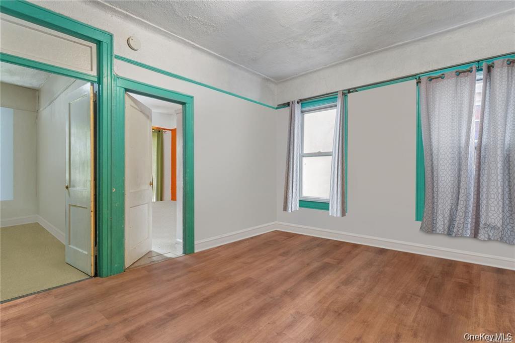 97-28 41st Avenue Queens, NY 11368 - Photo 14 of 29 an empty room with windows and closet