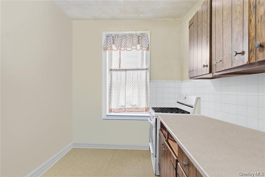 97-28 41st Avenue Queens, NY 11368 - Photo 18 of 29 a view of a kitchen with a sink cabinets and a window