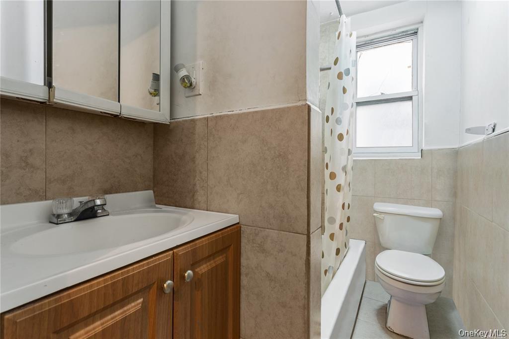 97-28 41st Avenue Queens, NY 11368 - Photo 20 of 29 a bathroom with a sink a toilet and window