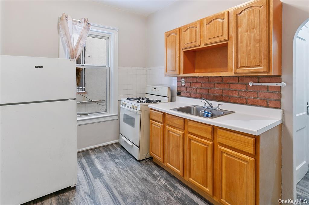 97-28 41st Avenue Queens, NY 11368 - Photo 4 of 29 a utility room with cabinets washer and dryer