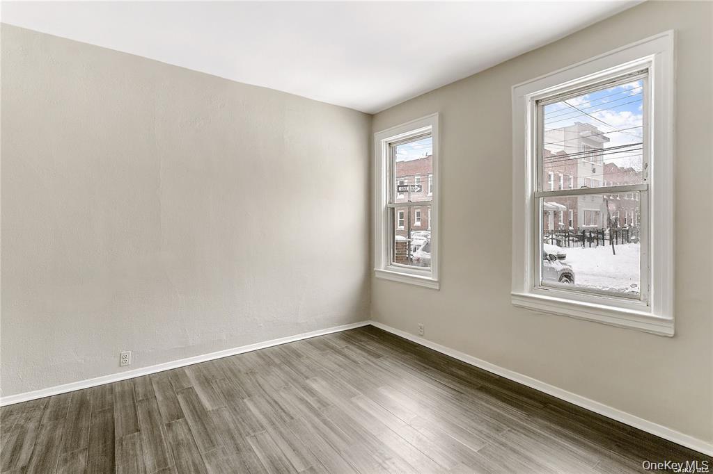 97-28 41st Avenue Queens, NY 11368 - Photo 8 of 29 an empty room with wooden floor and windows