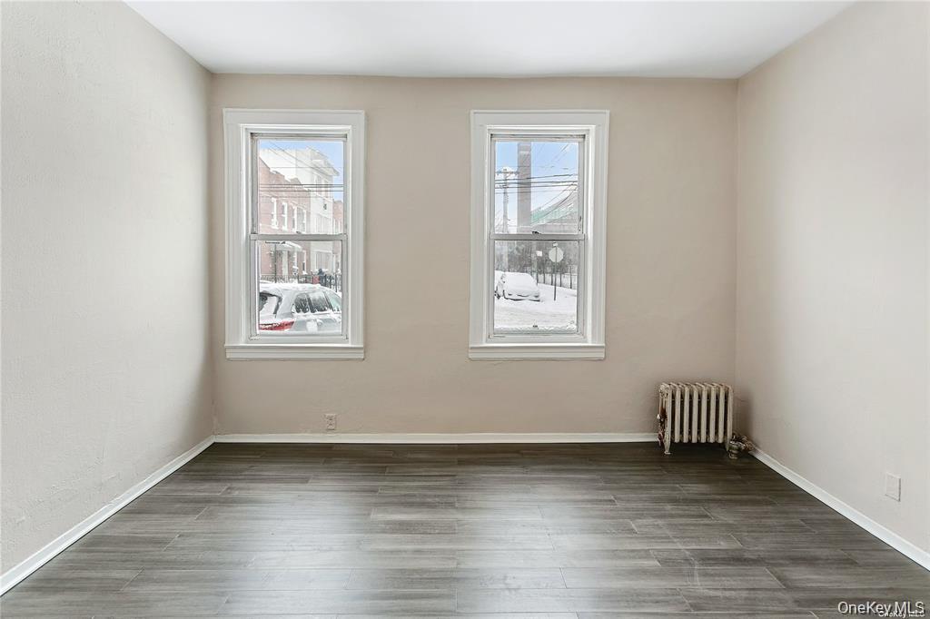 97-28 41st Avenue Queens, NY 11368 - Photo 9 of 29 an empty room with wooden floor and a window
