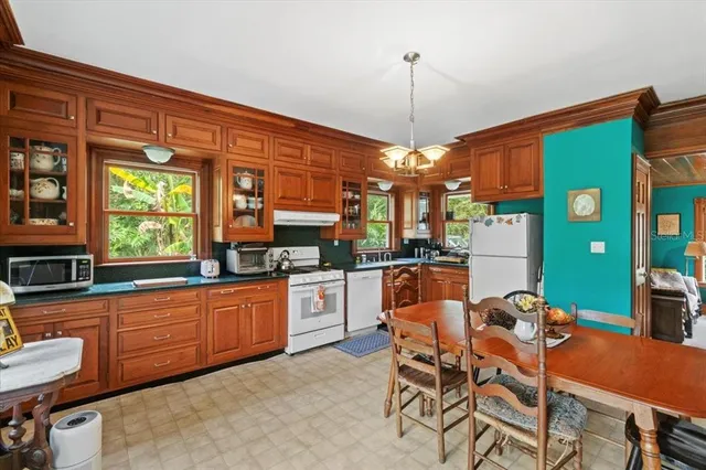 a dining table chairs and a chandelier