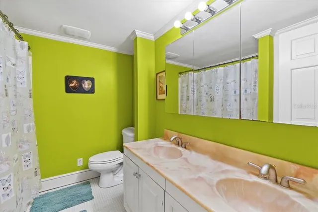 a bathroom with a sink mirror and a toilet