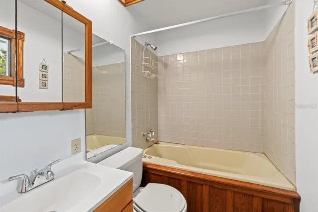 a bathroom with a sink a toilet and a bathtub