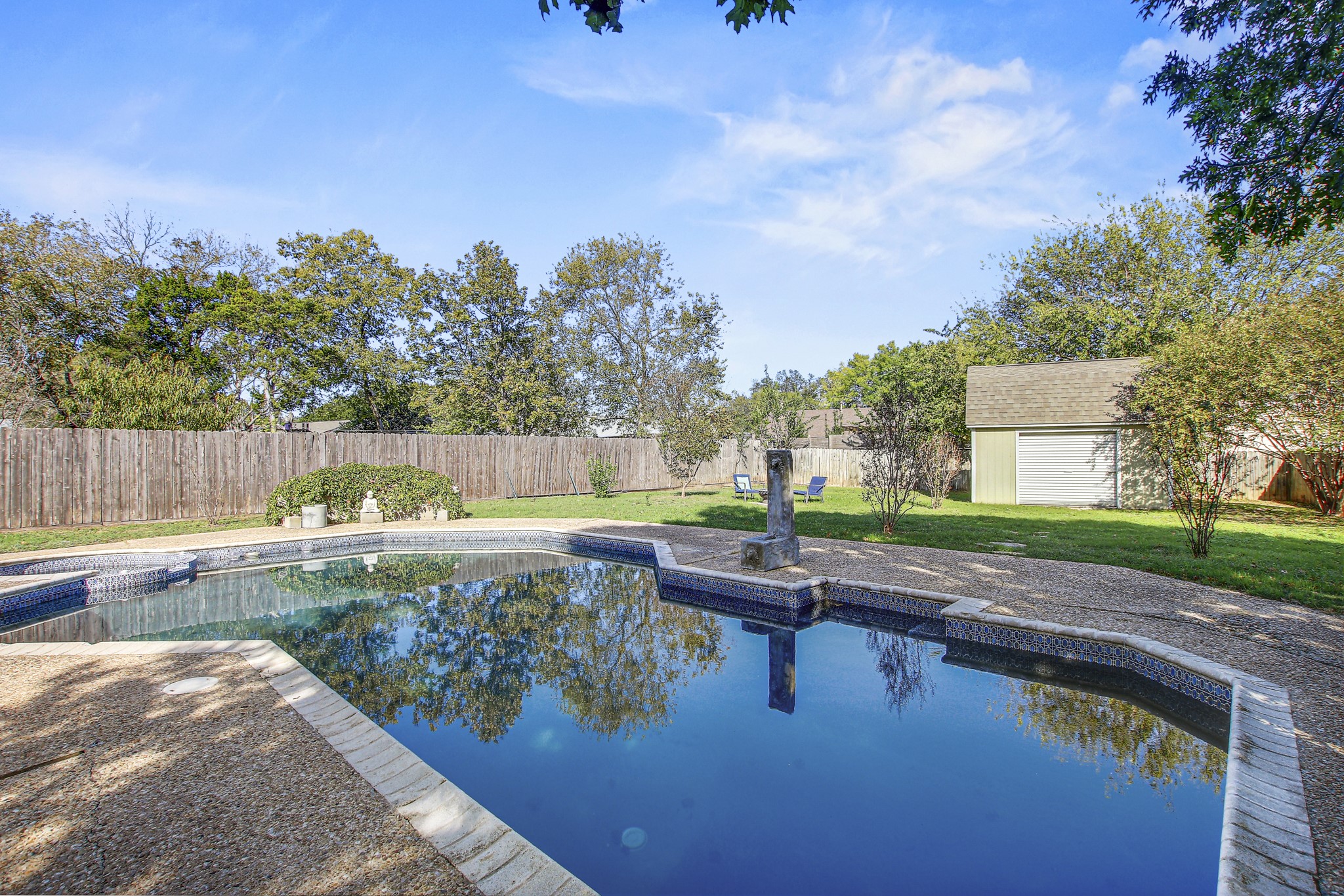 7741 Manassas Drive Austin, TX 78745 - Photo 1 of 39 View of swimming pool featuring an outdoor structure, a fenced backyard, and a patio