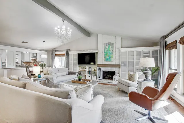 a living room with furniture fireplace and a flat screen tv